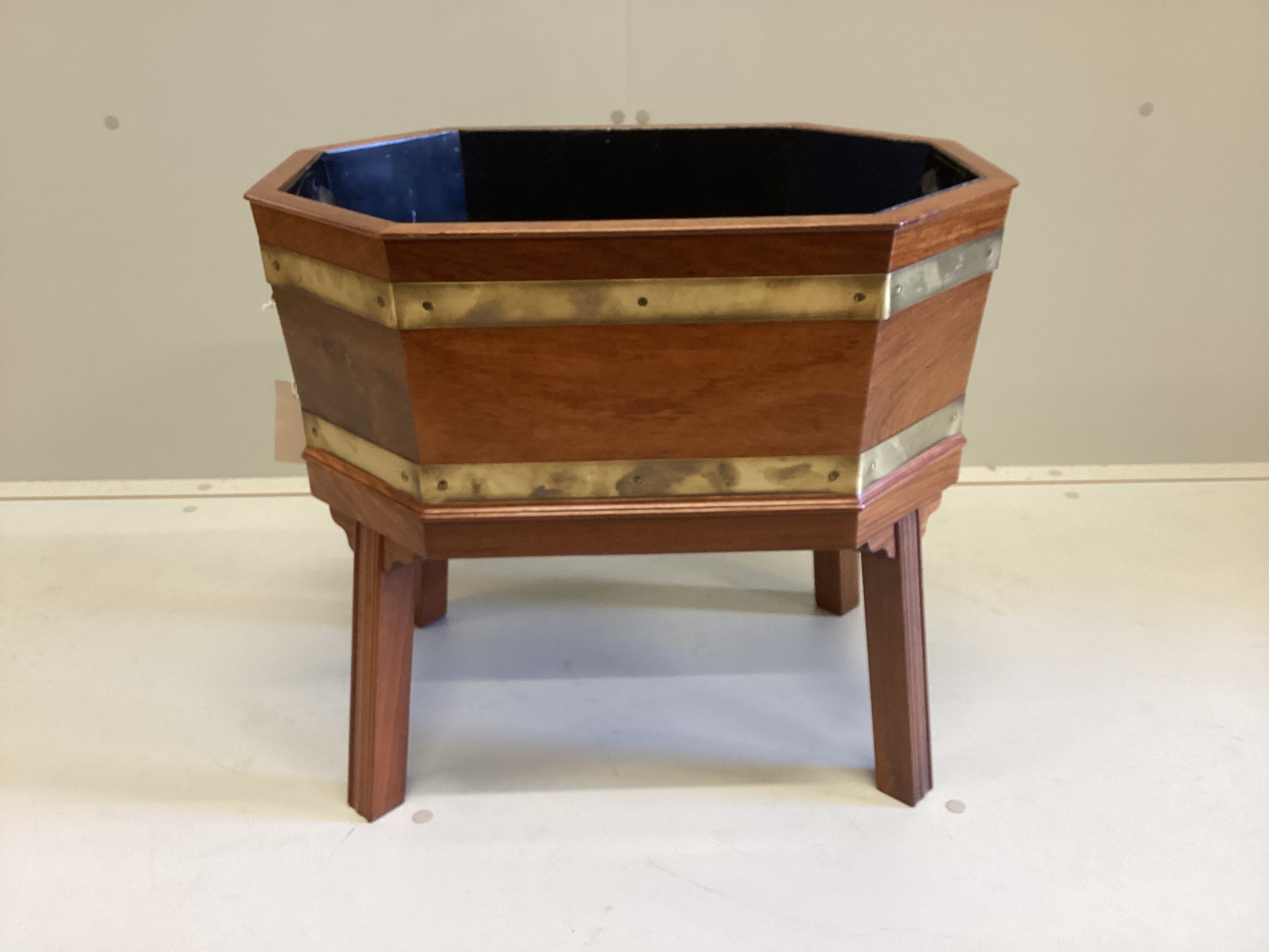 A George III style brass bound octagonal mahogany wine cooler, width 54cm, depth 39cm, height 48cm